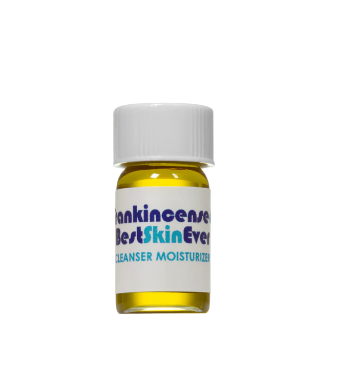 A small bottle of Living Libations skincare product with a white cap. The label on the bottle reads "Best Skin Ever Cleanser- Frankincense" in bold letters, highlighting it as a cleanser, exfoliator, and moisturizer. Infused with Frankincense Oil for acne redness soothing, the liquid inside is a vibrant yellow.