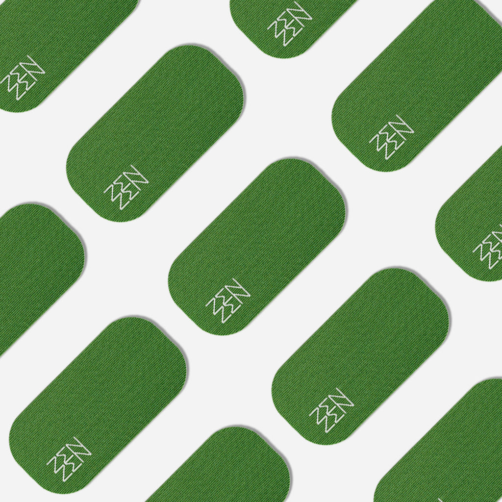 A repeating pattern of green, rounded rectangles on white, each with a white zigzag in one corner—reflecting the organic elegance of bamboo silk and Zenzen Tape motifs—adorns Zenzentape’s Evergreen Mouthtape.