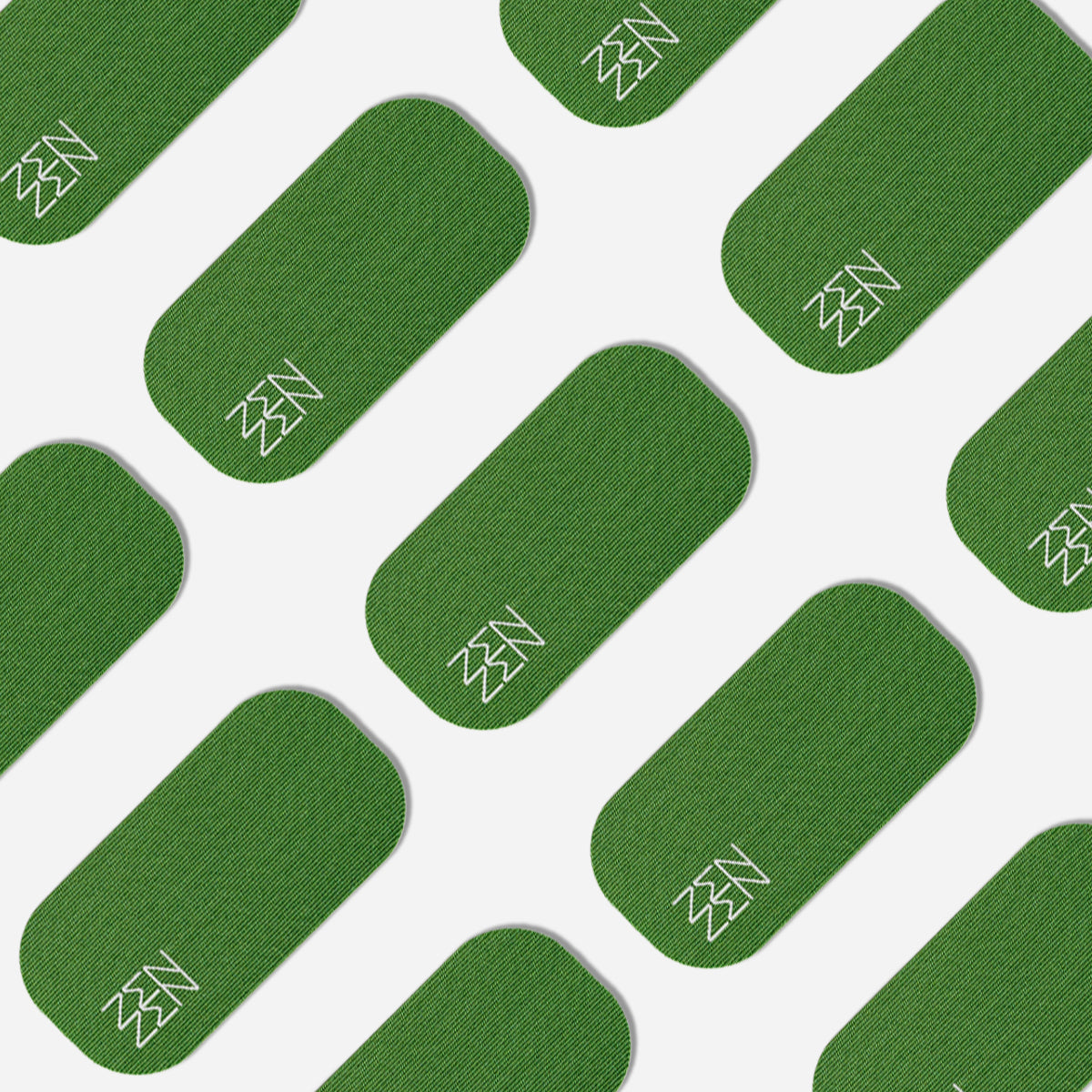 A repeating pattern of green, rounded rectangles on white, each with a white zigzag in one corner—reflecting the organic elegance of bamboo silk and Zenzen Tape motifs—adorns Zenzentape’s Evergreen Mouthtape.