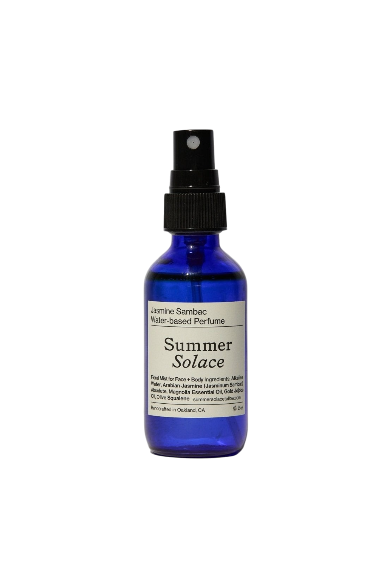 A blue glass spray bottle labeled "Jasmine Sambac + Magnolia Perfume Mist – Water-Based" by Summer Solace Tallow, with a black nozzle and a white label detailing ingredients and usage.