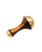 The Surya Kansa Wand is a handheld massager with a wooden handle and rounded, gold-colored metal ends—an essential Ayurveda skincare tool—shown on a plain white background.