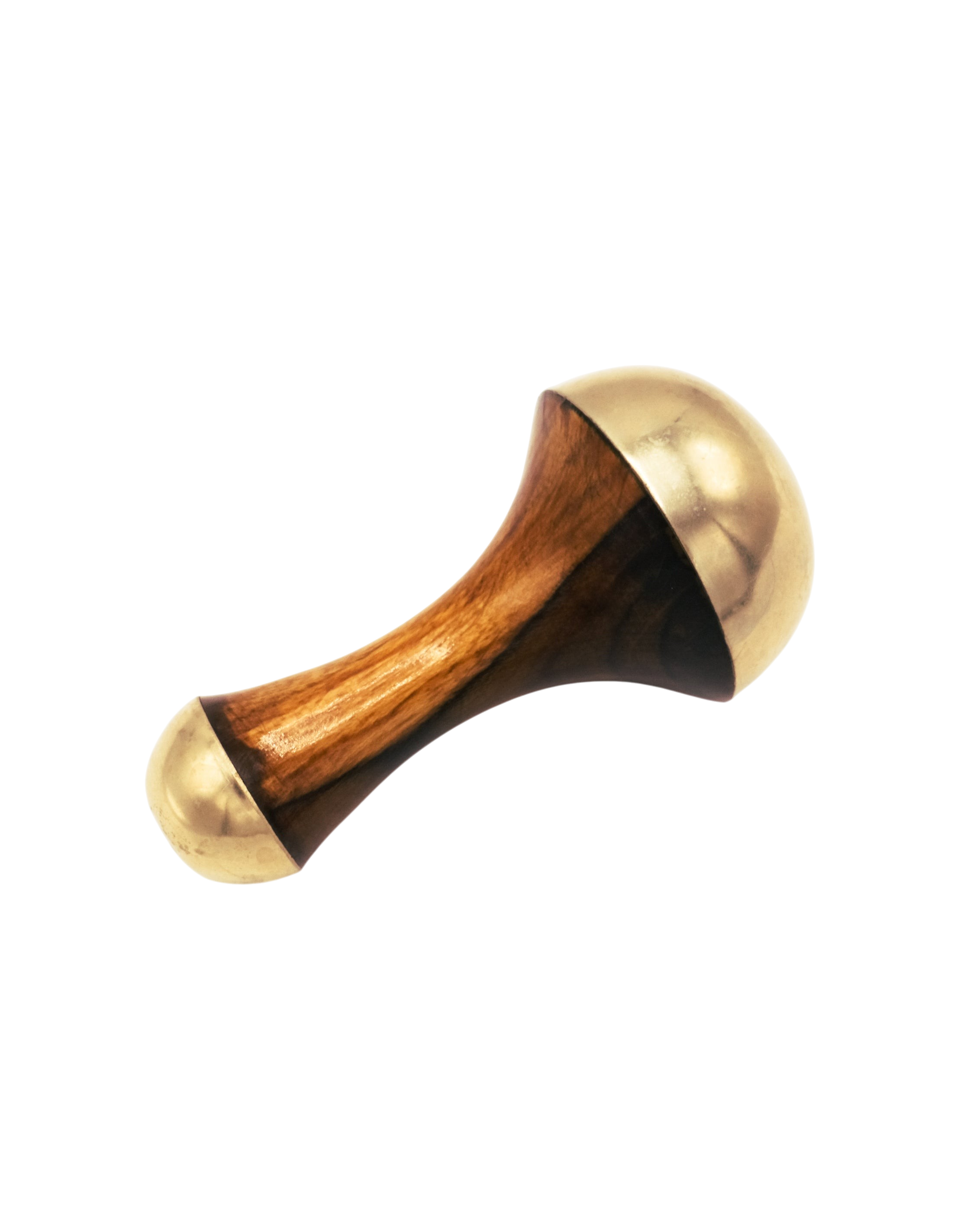 The Surya Kansa Wand is a handheld massager with a wooden handle and rounded, gold-colored metal ends—an essential Ayurveda skincare tool—shown on a plain white background.