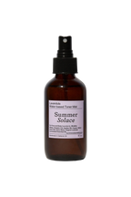 A brown spray bottle labeled "Lavender & White Lotus Toner – Organic Floral Mist" from Summer Solace Tallow, with a lavender label, shown against a plain white background.