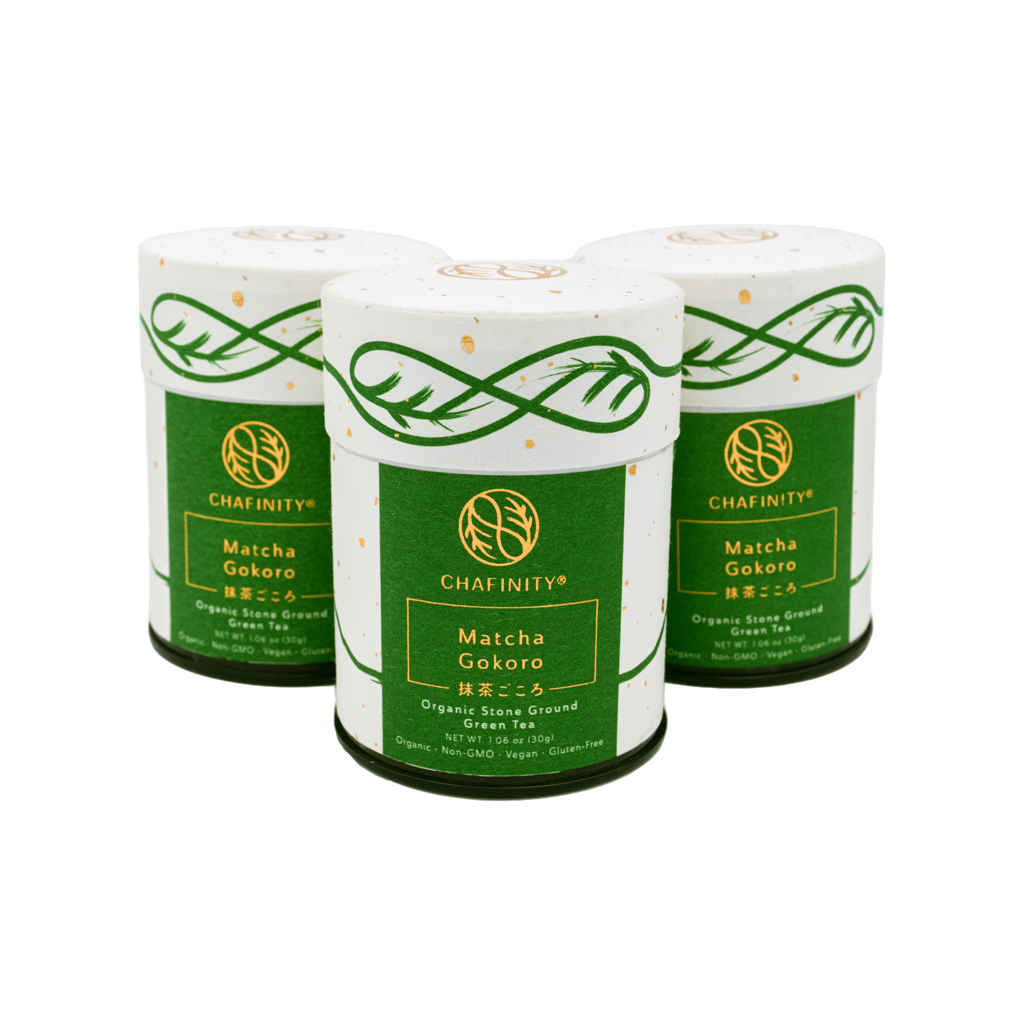 Three cylindrical containers of Chafinity Tea's Organic Stone Ground Ceremonial Matcha Gokoro are displayed against a black background. The containers feature a green and white design with gold detailing, embodying the essence of Japanese tea ceremonies. They are labeled as organic, stone-ground matcha green tea powder.