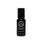 A small black bottle with a black cap labeled "Daughter Alchemy." The label features a decorative emblem with the initials "DA" inside a circular design. Below the logo, the text reads "Moon Mind® Meditative Body Oil," highlighting its essence as a meditative oil made from organic ingredients. The bottle contains 0.3 Fl Oz (15 ML) of liquid.