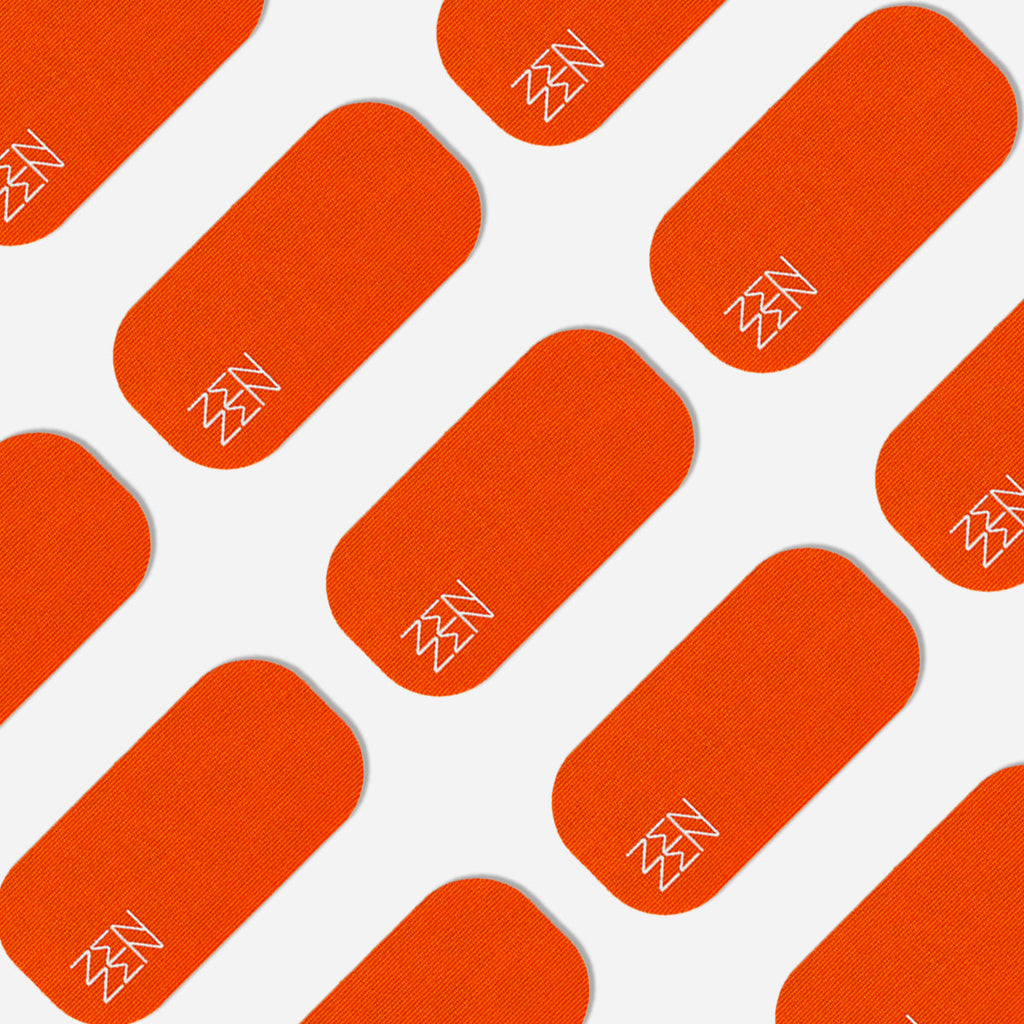 A repeating pattern of orange rounded rectangles with white zigzag accents in one corner, set diagonally on white, evokes organic bamboo silk. Inspired by Zenzentape, this design appears on the Socal Sunset Mouthtape.