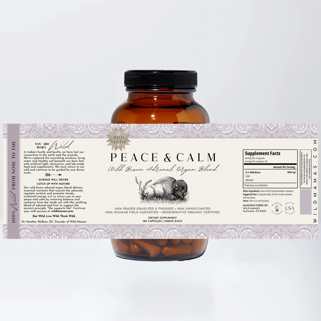 Amber bottle of Wild Mamas Peace and Calm—Wild Bison Adrenal Organ Blend supplements with a cream and lavender label showing product info and supplement facts, set against a plain white background.