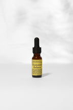 A small amber dropper bottle labeled "Summer Solace Tallow" rests on a white surface. Its label reads "Pear Gelato Body Oil – Zinc and Pearl Extract (Limited Edition)," showcasing this skin-brightening, rejuvenating body oil.