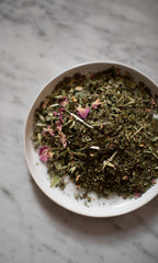 PLANTWALK FIELD | Everyday Minerals Herbal Infusion, a loose blend of dried herbs and flower petals for herbal mineral supplementation, rests on a light gray marble surface.
