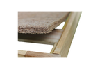 Close-up of a wooden frame with the CocoCoir Comfort Pad by Shepherd's Dream resting on top, showcasing its textured, woven coconut coir design. The focus is on the corner of the frame and the edge of the pad, emphasizing the contrast between the smooth wood and its rough texture.