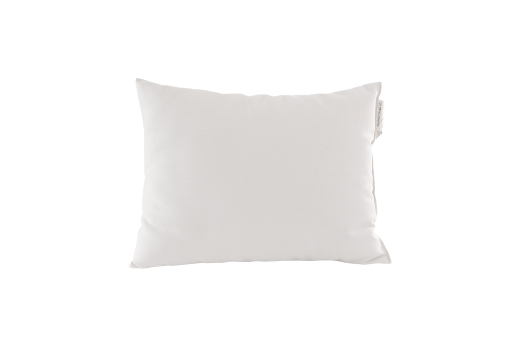 A plain white square pillow, known as the Child's Sleep Pillow by Shepherd's Dream, crafted from natural wool and featuring a subtle tag on the side, set against a transparent background.