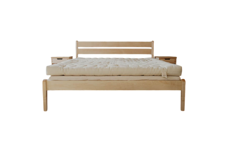 The Shepherd's Dream Cascade Latex Mattress Base features a minimalist wooden frame, natural Dunlop latex mattress, simple slatted headboard, and matching nightstands set against a white background.