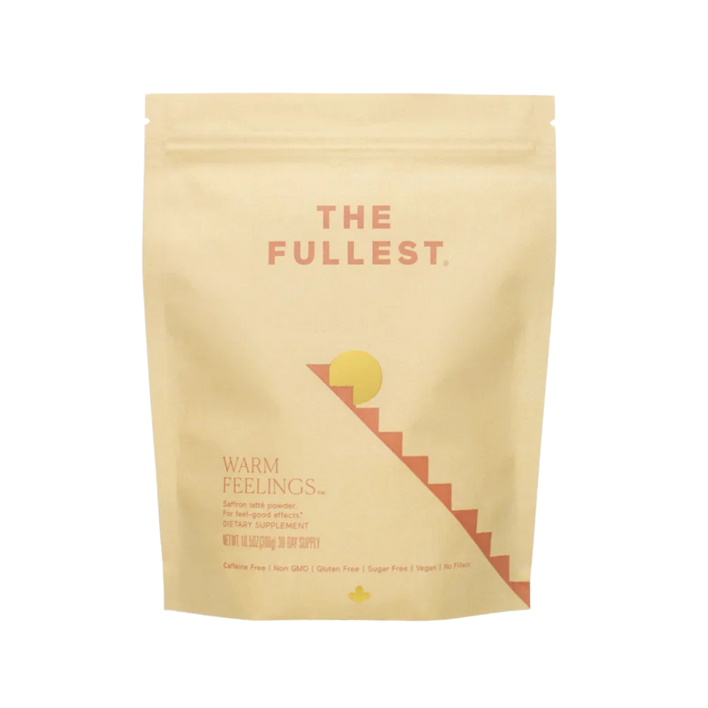 THE FULLEST’s Warm Feelings 30-Day Supply comes in a beige resealable pouch. The minimalist sun and staircase design reflect its mood-supporting, caffeine-free saffron formula—perfect for a calming daily latte ritual.
