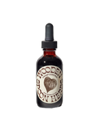 A dark glass dropper bottle labeled "Cramp Control Tincture" by WOODEN SPOON HERBS features a brown woven heart design and the text "dietary supplement 2 fl oz (59 ml)." Set against a black background, it supports a balanced cycle to help menstruate with ease.