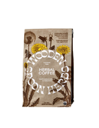 A brown paper bag of WOODEN SPOON HERBS Herbal Coffee, decorated with dandelion illustrations and labeled as a caffeine-free, adaptogenic coffee alternative.